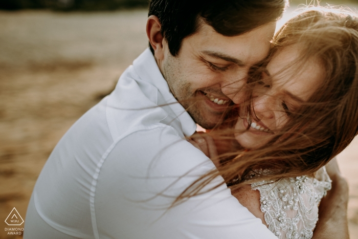 Engagement Photos from Praia do Rosa - Santa Catarina - Image contains: couple, hug, happiness, outdoors, smiles