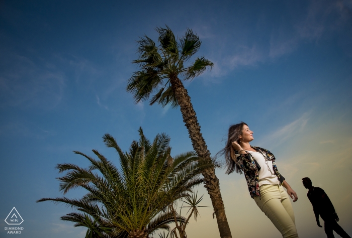 Engagement Photos from Almería - Spain | Image contains: palm trees, couple, sky, clouds