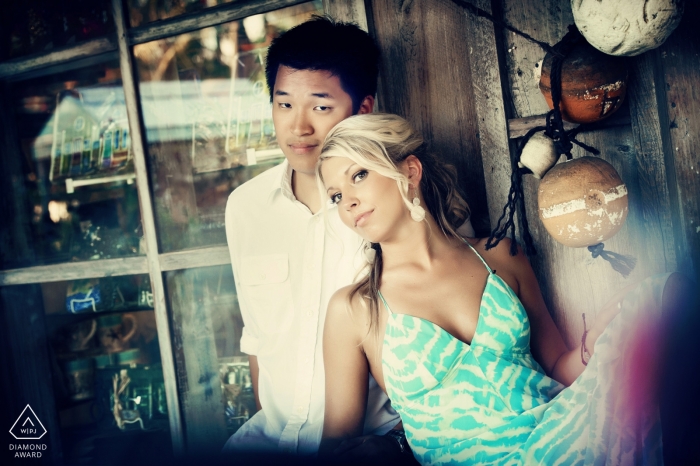 Photo by: <a href="https://www.wpja.com/photos/diamond-award-top-wedding-engagement-photographer/2549032">Julie Ambos - Key West Florida Engagement Photos from Ocean Key, Florida - Portrait contains: couple, window, reflections, buoys