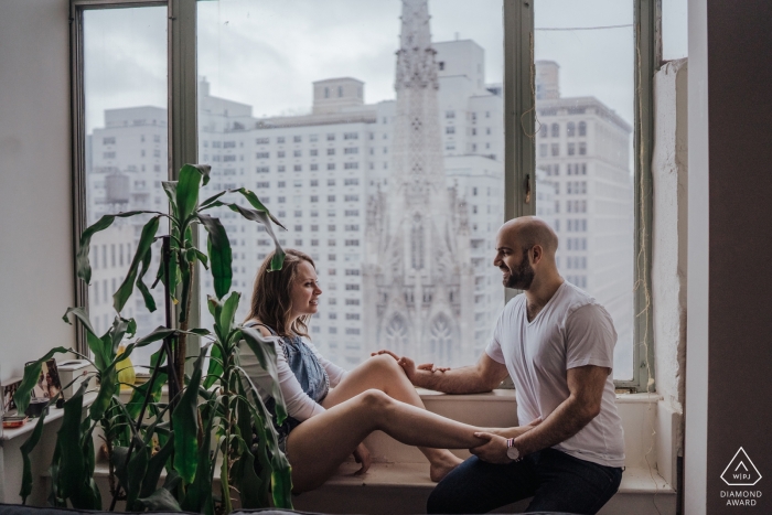 Photo by: <a href="https://www.wpja.com/photos/diamond-award-top-wedding-engagement-photographer/2549175">Chloe Delmonte - London London Engagement Photos from Soho - Couple hanging out in their apartment and just loving on each other. These two are a cultural blend of love and laughter. He's Israeli, she's Russian. They both live in NYC.