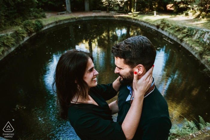 Photo by: <a href="https://www.wpja.com/photos/diamond-award-top-wedding-engagement-photographer/2549417">Andre Furtado - Vila Nova de Gaia Engagement Portrait from Tibães monastery - Braga - Portugal | Couple holding each other with lake in the background