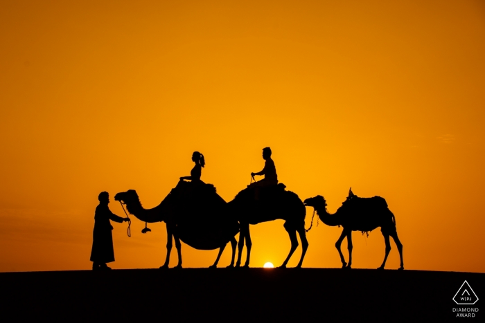 Engagement Portrait from Morocco Sahara Desert with a couple on camels Engagement Portrait from Morocco Sahara Desert - Image contains: camels, couple, desert, sunset, silhouette