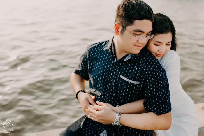 Engagement Photo from Ho Chi Minh City with a couple near water Engagement Photographer for Ho Chi Minh City - Portrait contains: hug, couple, water