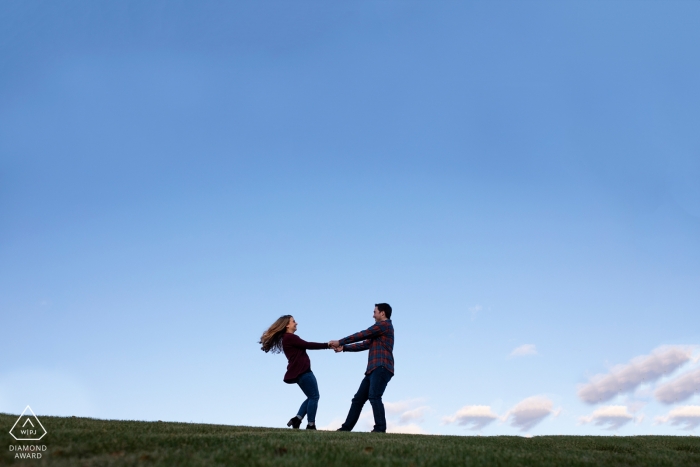 Photo by: <a href="https://www.wpja.com/photos/diamond-award-top-wedding-engagement-photographer/2554949">Lauren Hannah Garcia - Edmonton Alberta Millcreek Ravine, Edmonton Engagement Photography: Couple twirls at top of hill