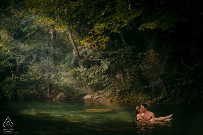 Tuscany, Val di Merse engagement portrait shoot with a ray of light through the trees 