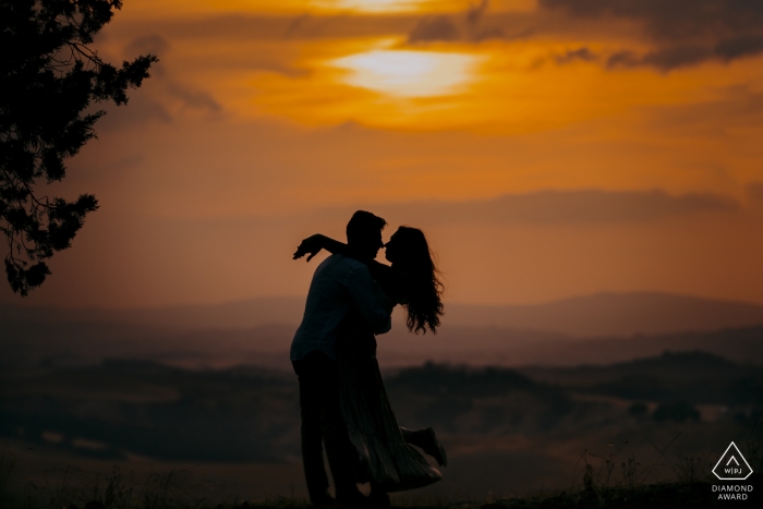 Photo by: <a href="https://www.wpja.com/photos/diamond-award-top-wedding-engagement-photographer/2555012">Marco Fantauzzo - Monteriggioni Siena Tuscany, a romantic embrace at sunset in Siena during engagement portrait shoot