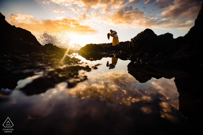 Photo by: <a href="https://www.wpja.com/photos/diamond-award-top-wedding-engagement-photographer/2558129">Angela Nelson - Makawao Hawaii Sunset reflections with waves - Couple dipping portrait - Wailea, Maui, Hawaii