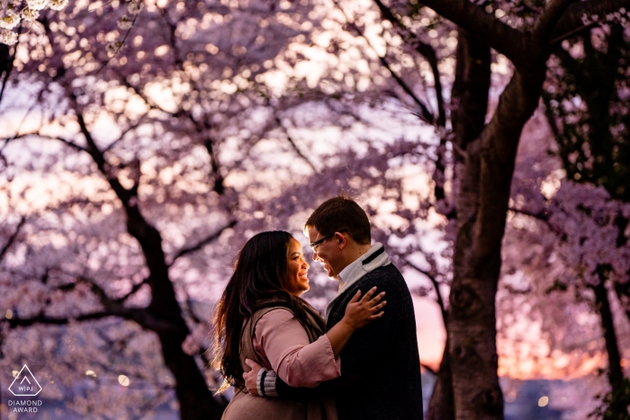 Photo by: <a href="https://www.wpja.com/photos/diamond-award-top-wedding-engagement-photographer/2560129">Brittany Diliberto - Arlington Virginia Tidal Basin, Washington DC Engagement photography session | A couple smiles at each other at sunrise, backlight by flash.