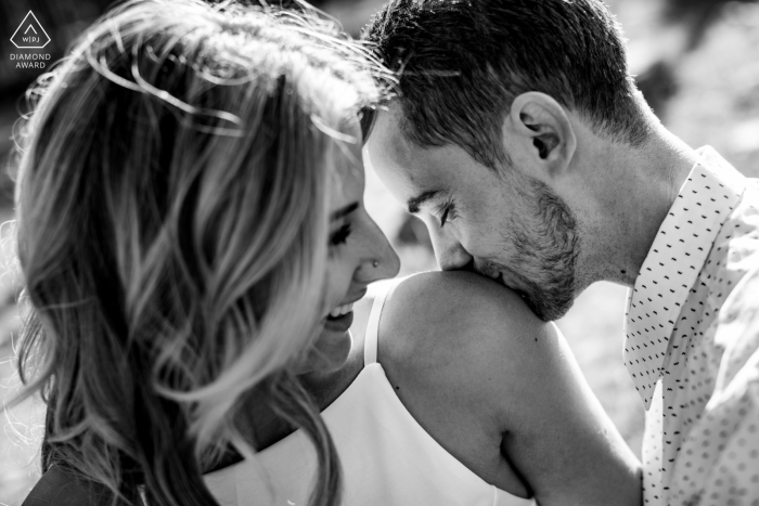 Engagement photos in Payson, Arizona with a kiss on her shoulder