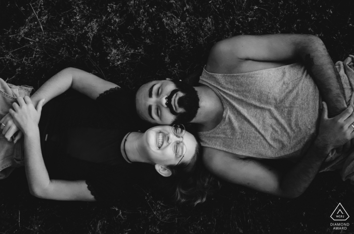 Couple laying down beside each other during engagement session at the Hotel Oberland, Nova Friburgo - RJ