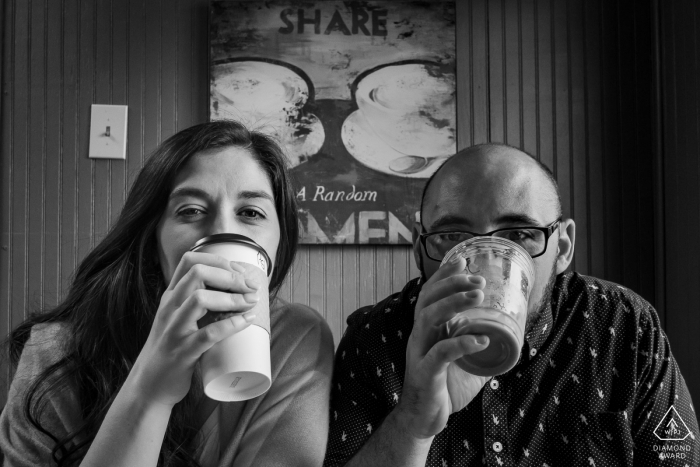 Photo by: <a href="https://www.wpja.com/photos/diamond-award-top-wedding-engagement-photographer/2562460">Cindy Brown - Atlanta Georgia Helen, GA engagement portrait - Couple drinking coffee below Share sign.