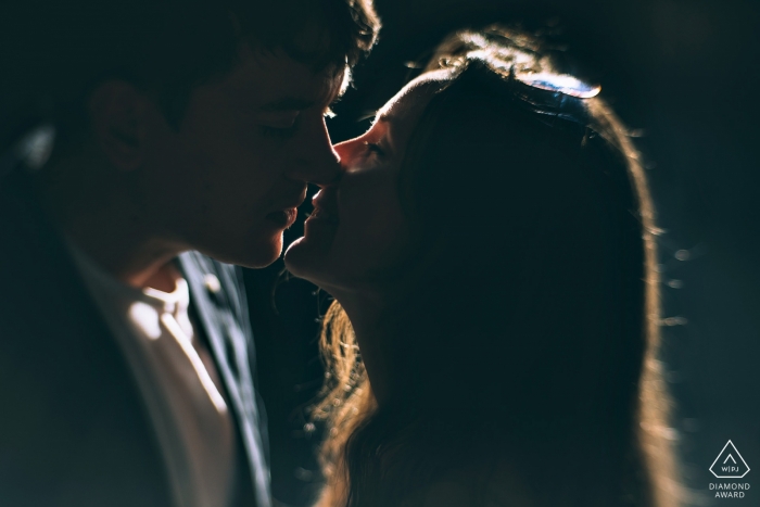 New York City couple portrait with natural rim light and a kiss.