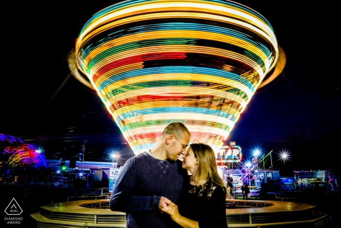 Photo by: <a href="https://www.wpja.com/photos/diamond-award-top-wedding-engagement-photographer/2562516">Simona Cancelli - Siracusa Siracusa Siracusa luna park slow-shutter engagement portrait with blur.