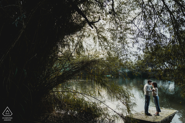 Photo by: <a href="https://www.wpja.com/photos/diamond-award-top-wedding-engagement-photographer/2563387">Federica Ariemma - Napoli Napoli Napes wedding photography. Image contains: trees, water, engaged couple, lake