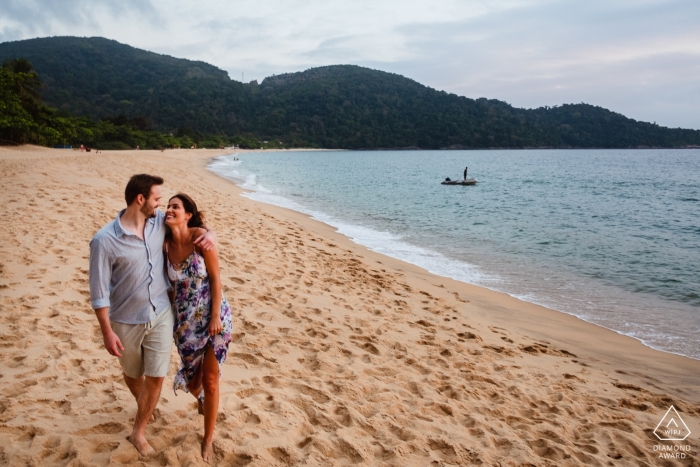 Minas Gerais engagement photographer available for beach portraits like this relaxed walking image Minas Gerais engagement photographer available for beach portraits.