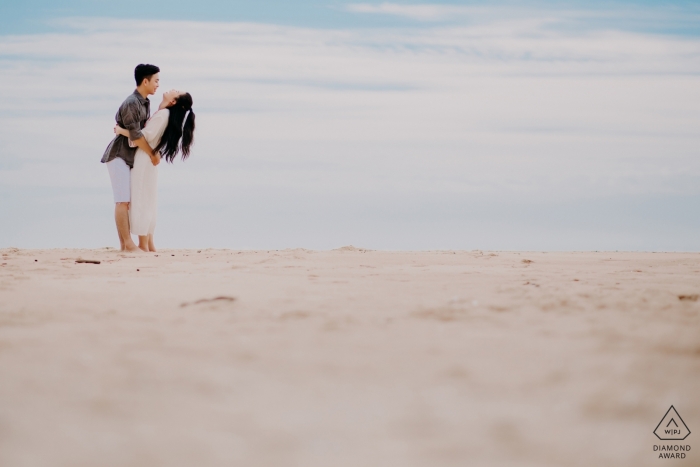Photo by: <a href="https://www.wpja.com/photos/diamond-award-top-wedding-engagement-photographer/2563562">Jacob Gordon - Perth Western Australia Ho Coc couple Laughing together on the beach during prewedding session.