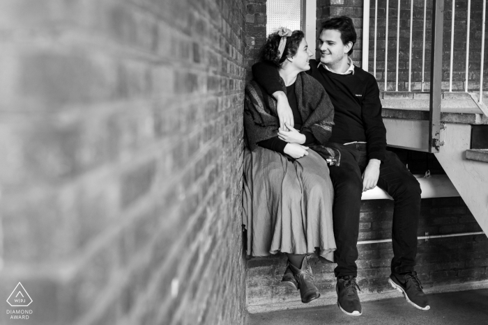 Couple sitting in an entrace lobby for prewedding portrait - Student home in Leiden, The Netherlands