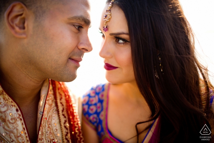 Boston, MA Couple looking at each other while posing for their engagement session photos.