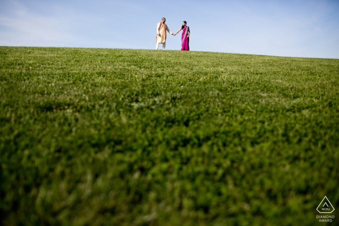 Couple on top of a green hill during Boston, MA engagement photography session