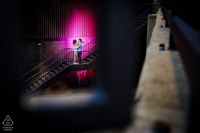 Photo by: <a href="https://www.wpja.com/photos/diamond-award-top-wedding-engagement-photographer/2565524">Victoria Sprung - Chicago Illinois Illinois engagement photo shoot - Chicago stairs, industrial session with a pink light