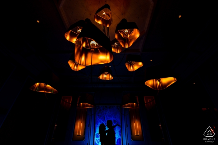 Photo by: <a href="https://www.wpja.com/photos/diamond-award-top-wedding-engagement-photographer/2566191">Alexis Rodriguez Montalvo - Sabana Grande St Regis Beach Resort, Rio Grande PR Engagement Couple Portrait - Image contains: Silhouette with a contrast with Blue and the warm color of the Chandelier