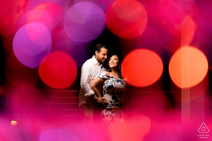 Courtyard by Marriott, Isla Verde PR Engagement Picture Session - Portrait contiene: Champagne Glasses per creare un bokeh che incornicia la coppia