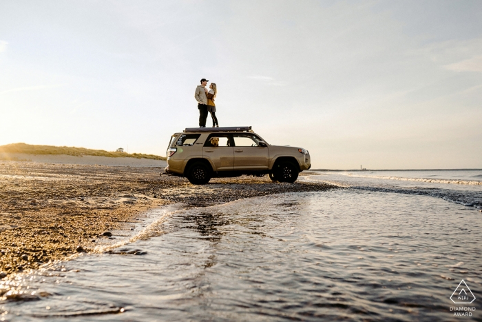 Cape Cod, MA Engagement Photo of a Couple at the beach with a 4x4 Cape Cod, MA Engagement Photo of a Couple - Portrait contains: 4x4, beach, sand, waves, water
