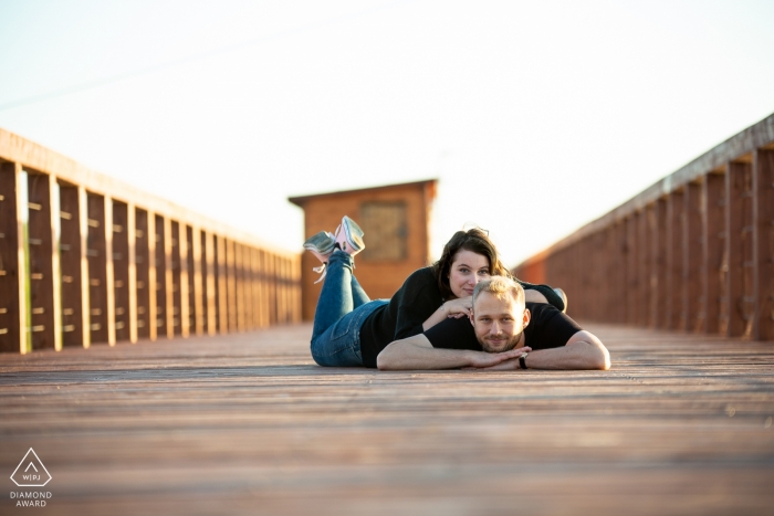 Jeziorsko Lake, PL Engagement Session with a couple - Portrait contains: lying, boardwalk, beach, sunlight, afternoon