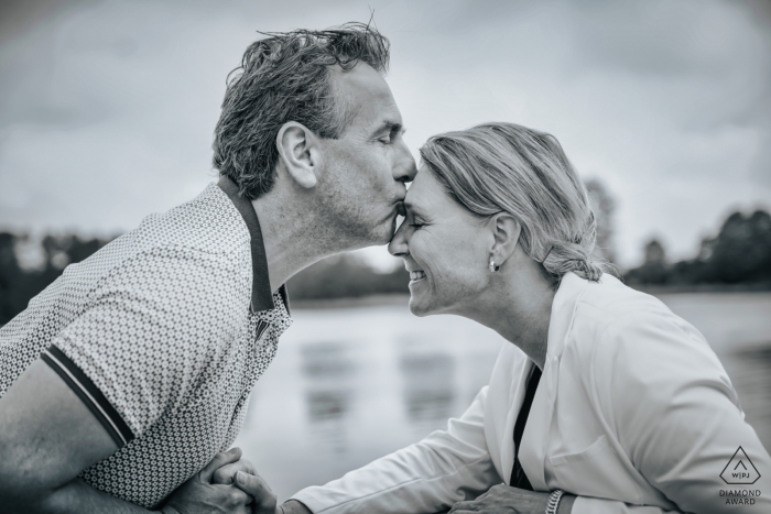 Photo by: <a href="https://www.wpja.com/photos/diamond-award-top-wedding-engagement-photographer/2568240">Gary Jahman - Hoofddorp Noord Holland Haarlemmermeerse Bos Engagement Portrait of a Couple - Image contains: Forehead kiss, black and white