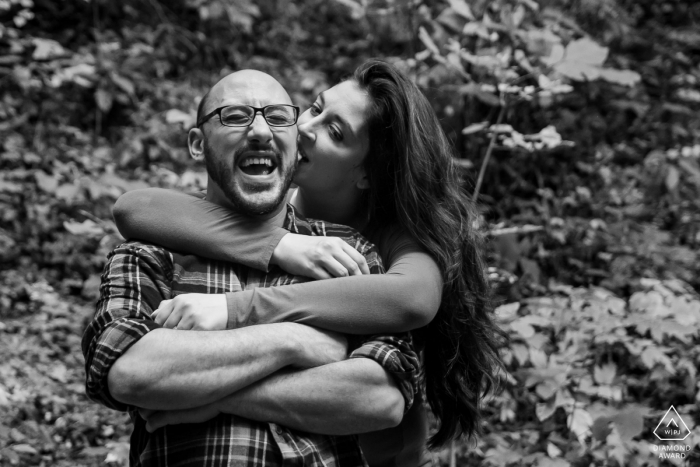 Helen, GA Engagement Couple Session - Image contains: bite, ear, laughing, fun, smiles, trees, black, white