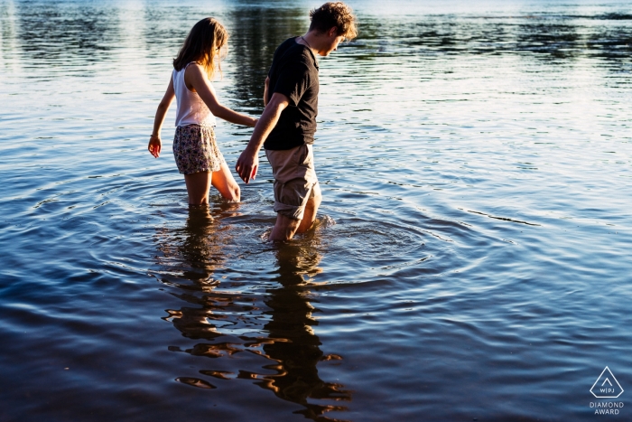 Wiesbaden, Germany Couple walking together in the river during engagement photo session