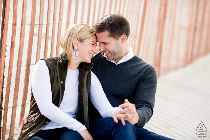 Rhode Island Couple Engagement Photo Session - Portrait contains: man, woman, sand, ocean, sitting on beach