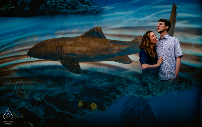 Waterfront Brewery, Key West, Florida Couple Portrait Photographer: really cool mural, but has really bad foreground. reflected the mural into my cell phone below lens to create the illusion that couple was inside the waterscape