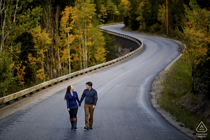 Photo by: <a href="https://www.wpja.com/photos/diamond-award-top-wedding-engagement-photographer/2571582">Justin Edmonds - Denver Colorado Engaged couple walk together on a road in Georgetown, CO - Pre Wedding Portrait Session