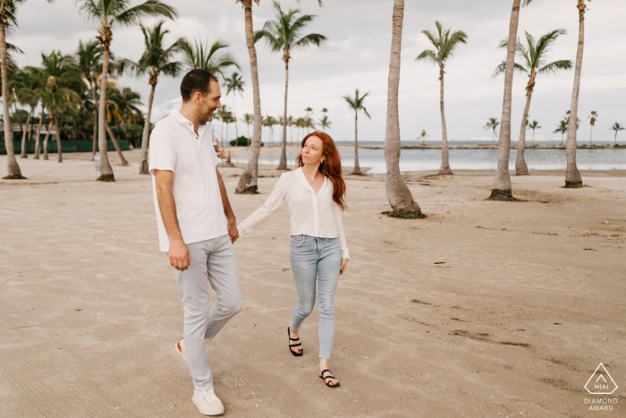 Engagement Portrait at Matheson Hammock Park, Miami, FL - Walking the sand between trees while holding hands.