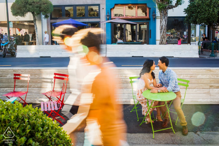couple engagement photography showing Love in the city and a couple Sitting at outdoor cafe table Los Gatos couple engagement photography | Love in the city - Sitting at outdoor cafe table