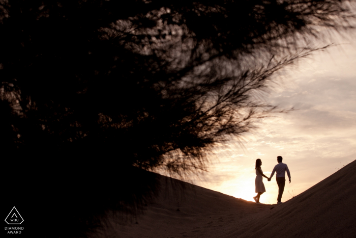 Melaka, Malaysia sunset couple walking and holding hands during engagement portraits