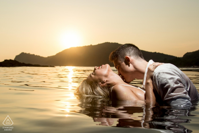 Photo by: <a href="https://www.wpja.com/photos/diamond-award-top-wedding-engagement-photographer/2574447">Eric Corbacho - São Caetano do Sul São Paulo Cambury, são paulo couple engagement photo taken at sunset deep in the water