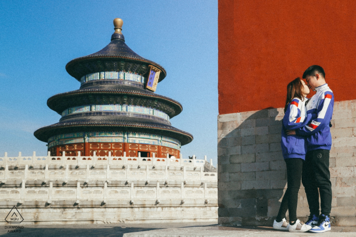 Beijing China Athletic Couple pose for an outdoor engagement portrait in the city.