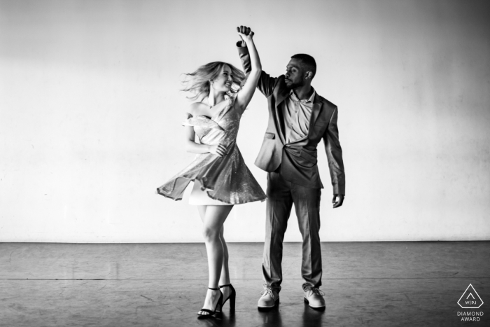 Photo by: <a href="https://www.wpja.com/photos/diamond-award-top-wedding-engagement-photographer/2574944">Shannon Cain - New Braunfels Texas Texas - Southern Dance Studio | A couple is Dancing and spinning during an indoor engagement photo session.
