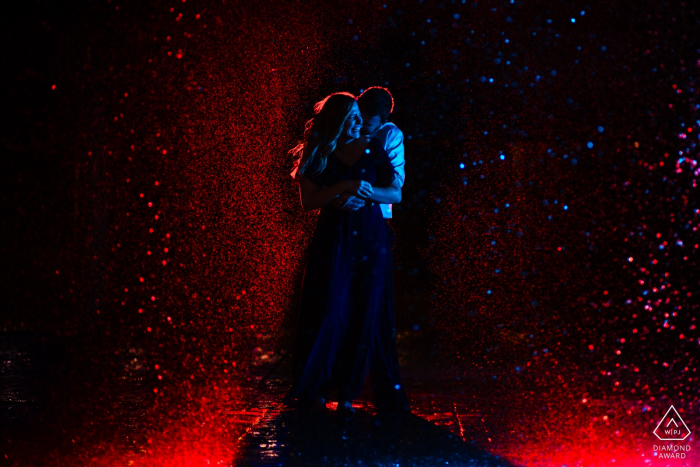 Photo by: <a href="https://www.wpja.com/photos/diamond-award-top-wedding-engagement-photographer/2574995">Shannon Cain - New Braunfels Texas San Antonio River Walk engagement session in water | Red and Blue Lights in Portrait