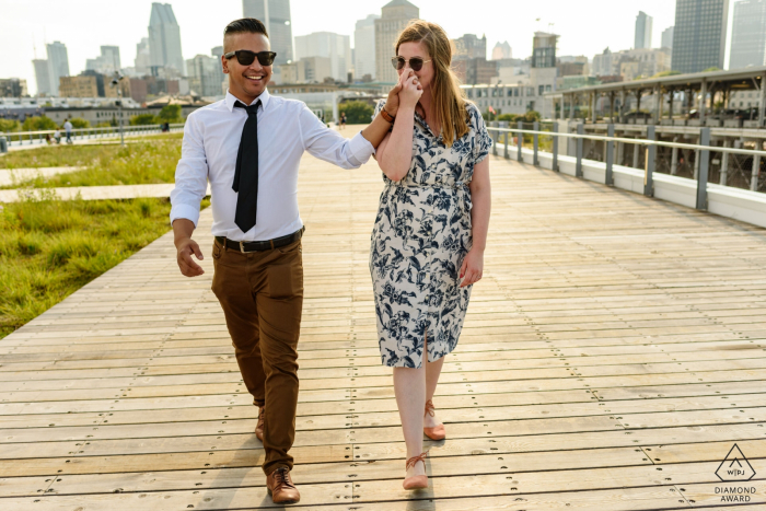 Photo by: <a href="https://www.wpja.com/photos/diamond-award-top-wedding-engagement-photographer/2575765">Esther Gibbons - Montreal Quebec Engaged couple walking on boardwalk, woman kissing man's hand - Old Montreal, Canada portrait session