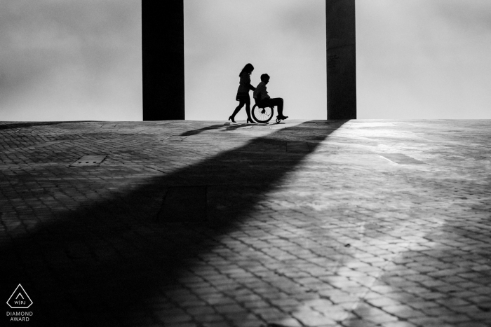 Photo by: <a href="https://www.wpja.com/photos/diamond-award-top-wedding-engagement-photographer/2576667">Pedro Vilela - Lisboa Lisboa Couple Portrait in Black and White | Wheel Chair and Shadows
