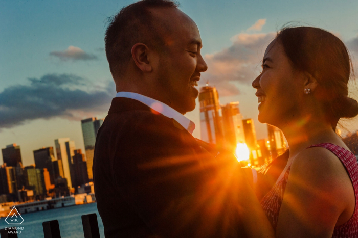 Weehawken New Jersey engagement photos with the city and the sun and the expressions. 