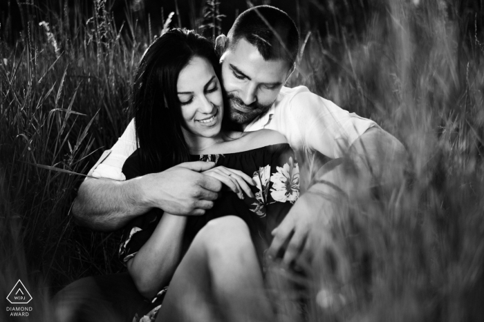 Sofia-Bulgarien Fotoshooting vor der Hochzeit mit einem Paar, das im hohen Gras sitzt.