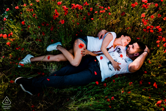 Pre wedding portrait shoot with a couple lying down in a field of flowers Sofia-Bulgaria Pre wedding portrait shoot with a couple lying down in a field of flowers