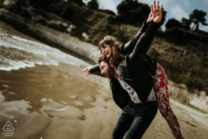 engagement photo with a Woman on the back of her future husband on the beach Royan, Charente-maritime, France engagement photo - Woman on the back of her future husband on the beach