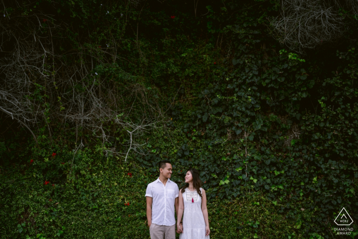 Photo by: <a href="https://www.wpja.com/photos/diamond-award-top-wedding-engagement-photographer/2579182">Leo Do - Fullerton California Corona del Mar State Beach, CA engagement session | Happiness is your best friend, love and a tall ivy wall for a green background