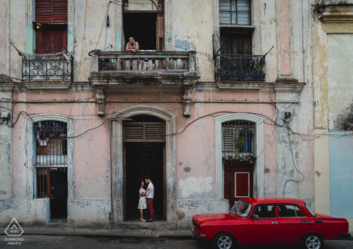 Cuba engagment shoot in the streets with a red car.