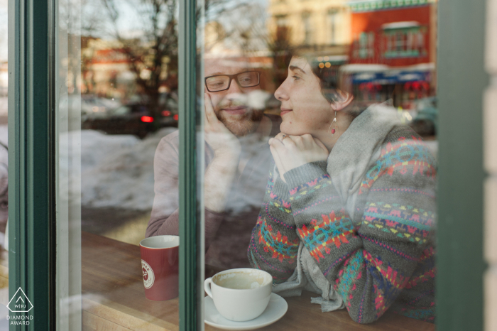 A couple snuggling in a Albany, New York cafe photographed though the window from the outside 